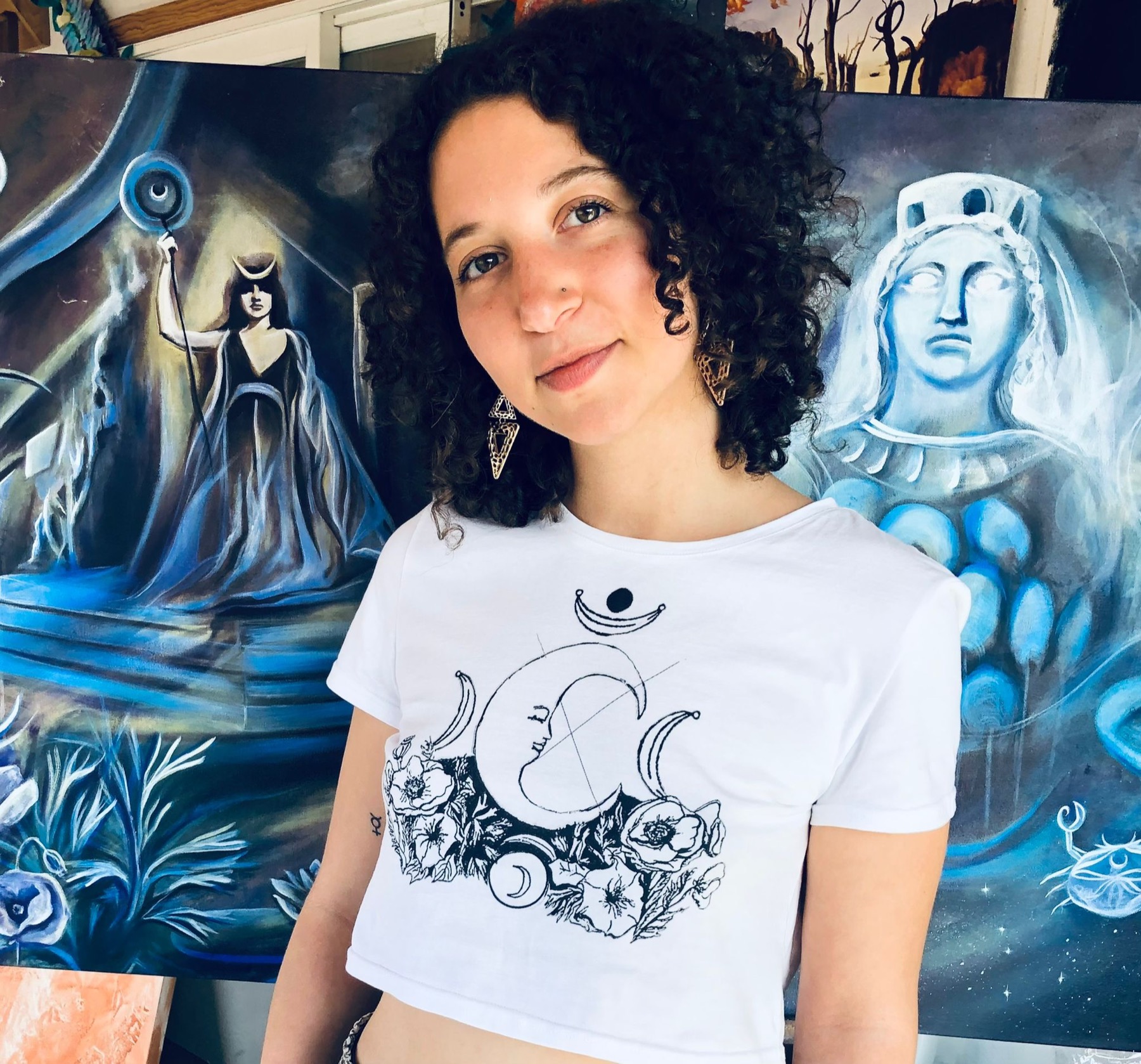 Amelia Passer in front of one of her paintings